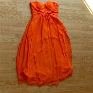 A beautiful vibrant strapless orange dress (prom)